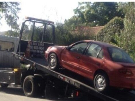 Red car on a tow truck.