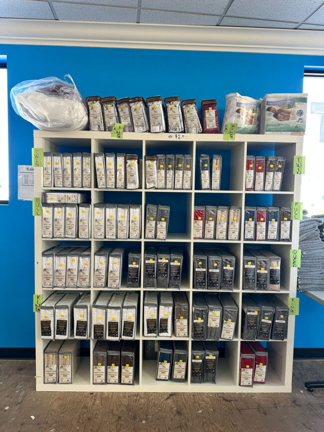 Varity of linens on shelves.