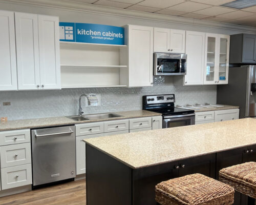 Fully remodeled kitchen with island and stools for store sample viewing.