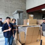 Young volunteers unloading boxes.