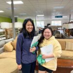 Two lady volunteers smiling in the ReStore.