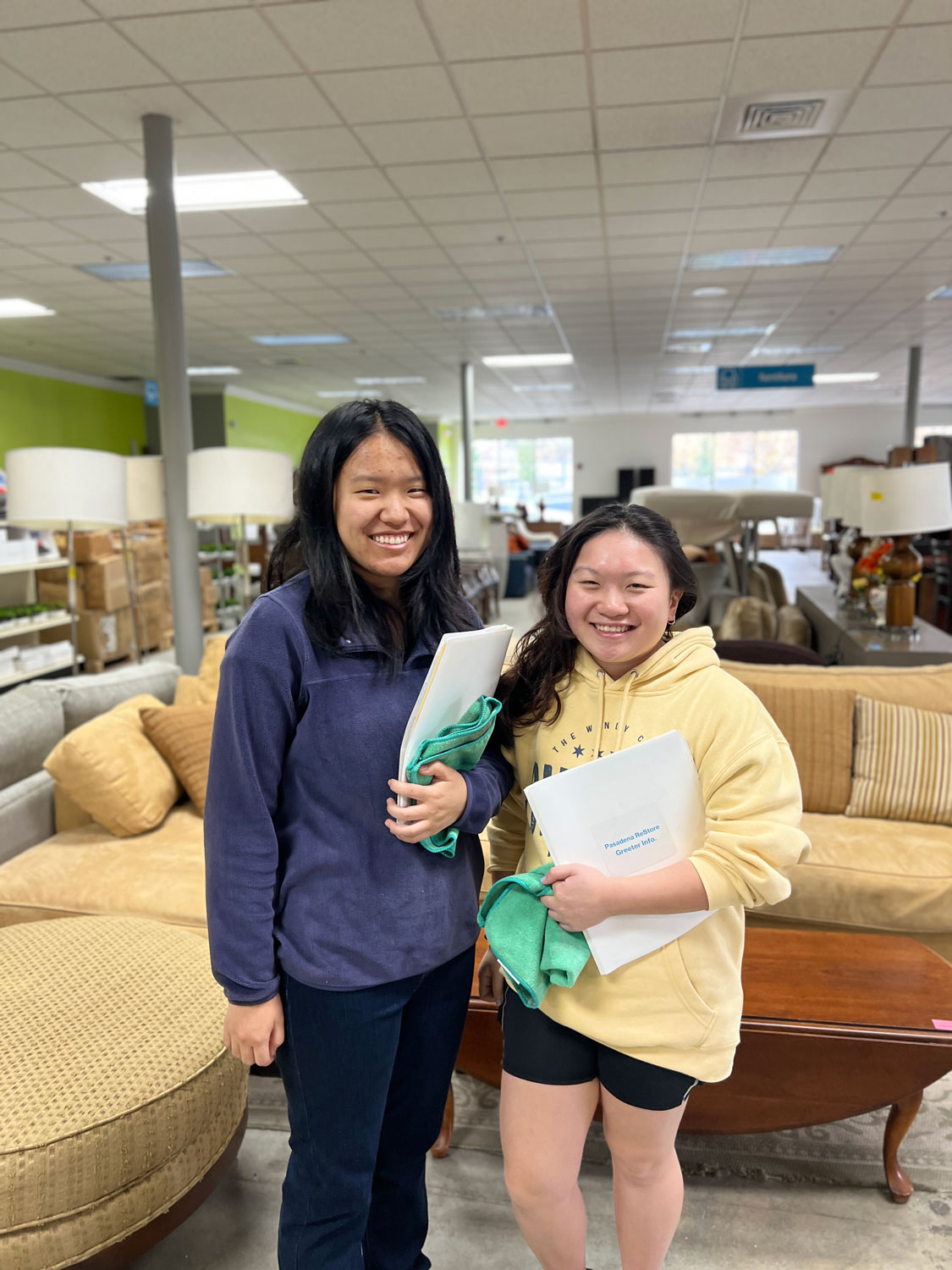 Two lady volunteers smiling in the ReStore.